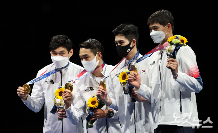 왼쪽부터 구본길, 김정환, 김준호, 오상욱이 28일 일본 지바의 마쿠하리 메세에서 열린 2020도쿄올림픽 펜싱 남자 사브르 단체전 시상식에서 금메달을 들어보이고 있다. 올림픽사진공동취재단
