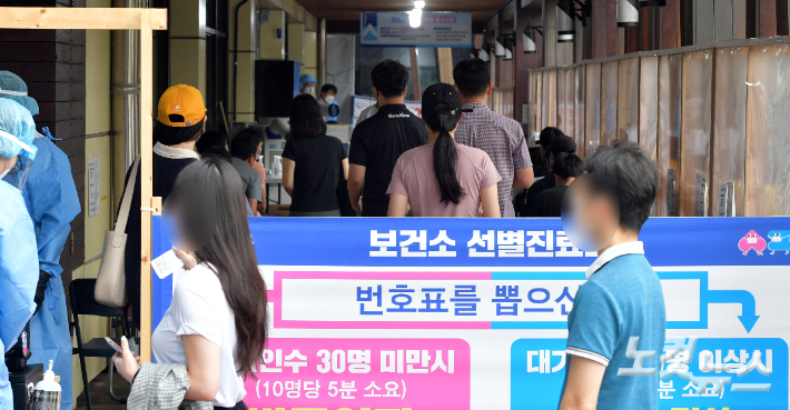 지난 25일 서울 송파구 보건소 선별진료소에서 시민들이 검사를 받기 위해 줄을 서 있다. 박종민 기자