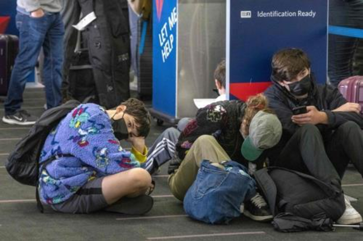 23일(현지시간) 미국 로스앤젤레스국제공항에서 여행자들이 델타항공 카운터 앞에 앉아있다. 연합뉴스