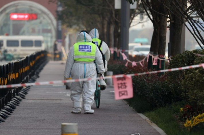 중국 북부 산시성 시안시에서 22일 방역복을 입은 보안요원들이 신종 코로나바이러스 감염증(코로나19) 확산 방지를 위한 봉쇄 지역 안을 걸어가고 있다. 연합뉴스