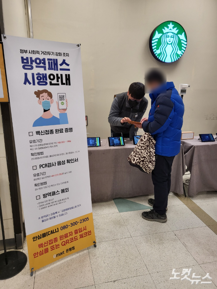 서울 은평구에 위치한 이마트 은평점에서 고객이 마트 입장 전 직원에게 백신 인증서를 제시하고 있다. 조혜령 기자