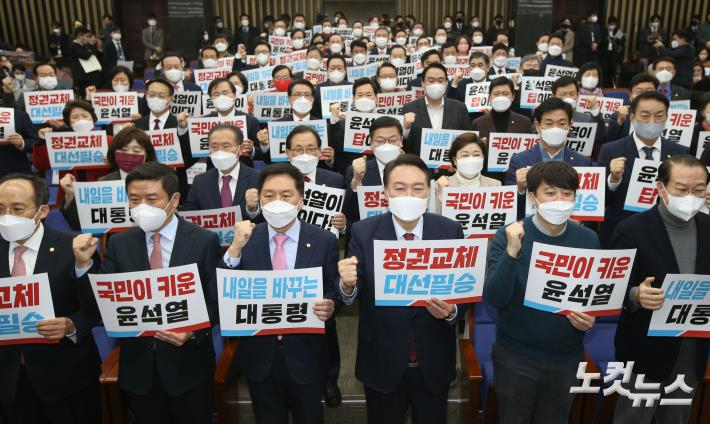 국민의힘 윤석열 대선 후보, 이준석 대표, 권영세 선거대책본부장, 김기현 원내대표 등 의원들이 14일 국회에서 열린 의원총회에서 손피켓을 들고 구호를 외치고 있다. 윤창원 기자