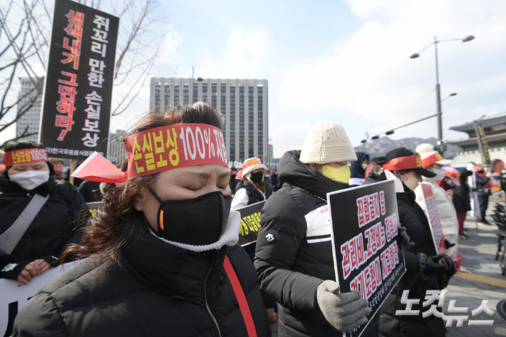 코로나피해자영업총연합(코자총) 참석자들이 지난 15일 서울 광화문 시민열린마당에서 열린 '코로나 피해 정부 규탄 결의대회'에서 묵념을 하고 있다. 이한형 기자