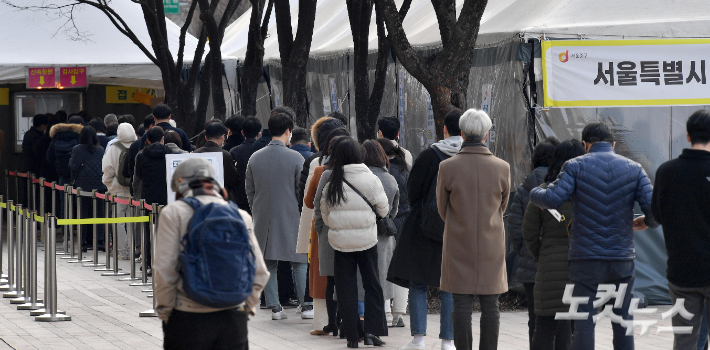코로나19 신규 확진자가 20만9169명으로 열흘 만에 20만명대를 기록한 21일 서울광장에 마련된 임시선별검사소를 찾은 시민들이 검사를 받기 위해 줄을 서 있다. 박종민 기자