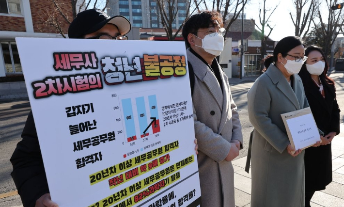 지난 1월 서울 헌법재판소 앞에서 세무사시험제도개선연대 관계자 등이 세무사 자격시험이 세무공무원 출신 응시자에게 절대적으로 유리해 일반 응시자가 큰 피해를 봤다는 내용의 헌법소원 심판 청구서를 들고 있다. 연합뉴스