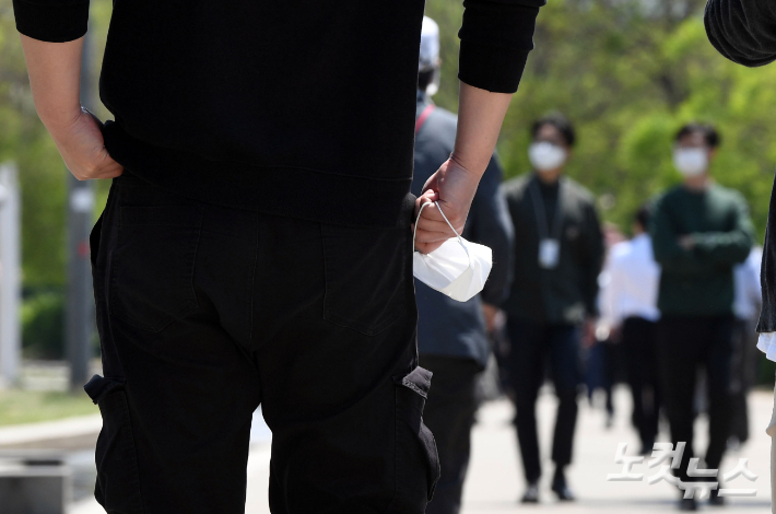 지난 2020년 10월 13일 이후 566일 만에 실외마스크 착용 의무가 해제된 2일 서울 여의도 한강공원을 찾은 한 시민이 마스크를 손에 든 채 산책을 하고 있다. 황진환 기자
