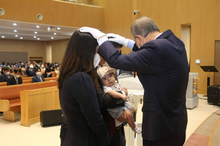 지난달 26일 주일예배에서 아기 축복기도를 받고 있는 김성록·전진아 집사 가정의 자녀 김윤호