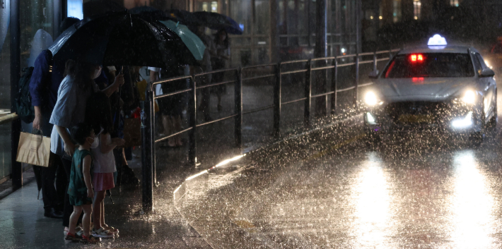 폭우가 내린 8일 오후 시민들이 서울 용산구 용산역 인근 택시승차장에서 택시를 타기 위해 줄을 서고 있다. 연합뉴스