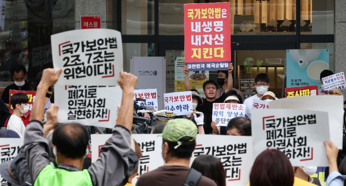 15일 서울 종로구 헌법재판소 앞에서 국가보안법 위헌결정을 요구하는 국가보안법폐지국민행동(아래)과 국가보안법에 찬성하는 대한민국 애국순찰팀 등 보수단체 회원들(위)이 손팻말을 들고 있다. 연합뉴스