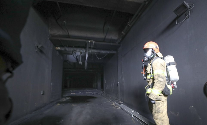 지난 9월 화마가 휩쓸고 지나간 대전 현대프리미엄아울렛 지하주차장 입구 모습을 소방대원이 설명하고 있다. 연합뉴스