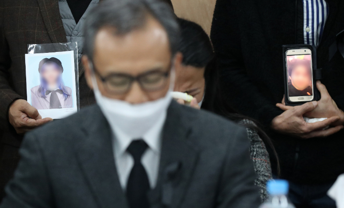 이태원 참사 유가족들이 22일 오전 서울 서초구 민주사회를 위한 변호사모임(민변)에서 열린 입장발표 기자회견에서 희생자들의 사진을 들고 눈물을 흘리고 있다. 연합뉴스