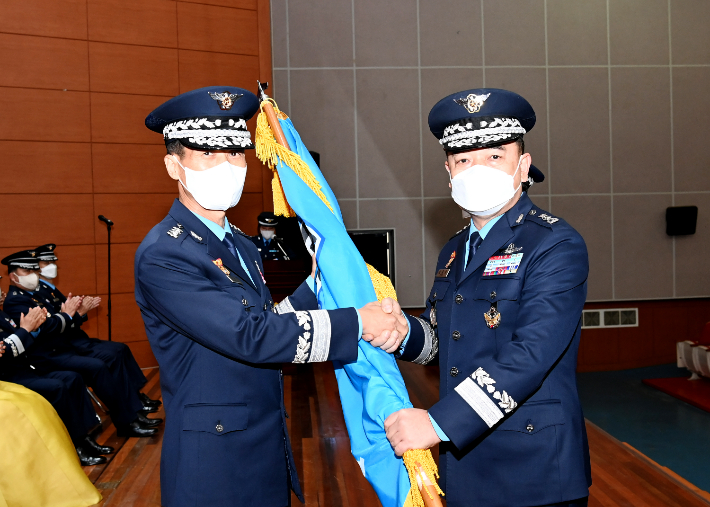 8일 열린 이·취임식에서 박하식 공군 작전사령관(좌측)과 최춘송 제8대 기동정찰사령관(우측)이 부대기를 이양하고 있다. 공군 공중기동정찰사령부 제공