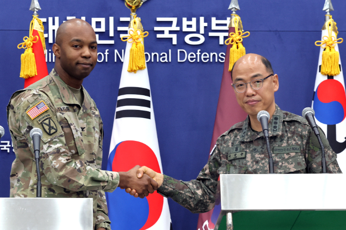 이성준 합동참모본부 공보실장과 아이작 테일러 한미연합사 공보실장이 3일 오전 서울 용산구 국방부에서 열린 한미 '2023 자유의방패(FS)' 연합연습 공동 브리핑'에서 "같이 갑시다(We go together)"를 외친 뒤 악수하고 있다. 연합뉴스