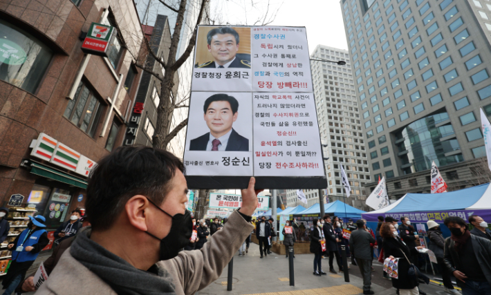 지난 4일 오후 서울 중구 숭례문 앞 대로에서 촛불행동 주최로 열린 29차 촛불대행진에서 한 참가자가 아들의 학교폭력(학폭) 전력이 드러난 정순신 변호사를 규탄하는 손피켓을 들고 있다.  연합뉴스