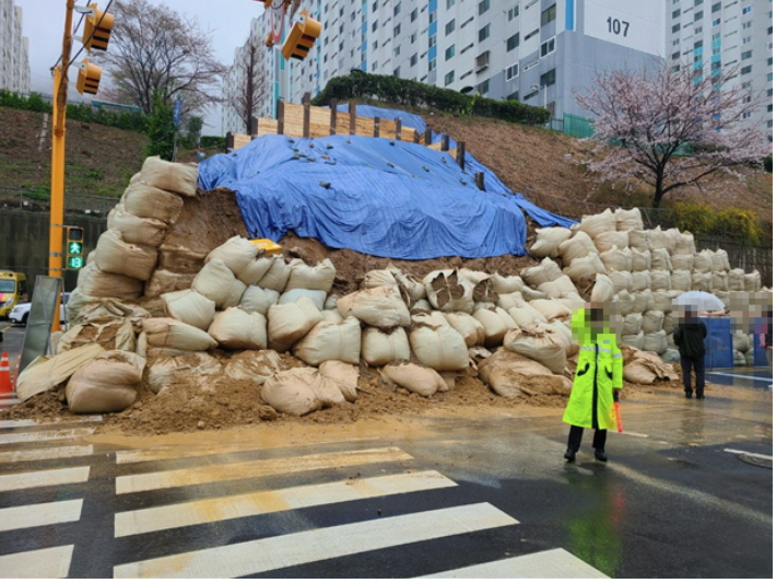 부산의 한 아파트 옹벽 공사 현장에서 흙더미가 쏟아져 도로가 통제됐다. 이날 부산지역에는 61.2㎜에 달하는 제법 많은 비가 내렸다. 부산경찰청 제공