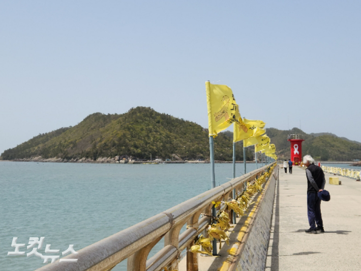 13일 전남 진도군 진도항에 '세월호 기억의 벽'을 유심히 읽고 있는 한 노인의 모습. 박성은 기자