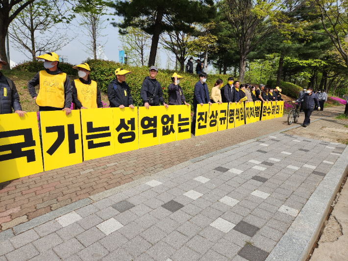 진상규명을 요구하는 피켓을 들고 있는 4.16 재단 관계자들. 이준석 기자