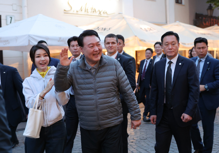 북대서양조약기구(NATO·나토) 정상회의 참석차 리투아니아를 방문 중인 윤석열 대통령과 김건희 여사가 10일(현지시간) 빌뉴스 구시가지를 산책하던 중 식당 야외 자리에서 식사 중인 피트 리케츠 미국 상원의원과 인사하고 있다. 연합뉴스