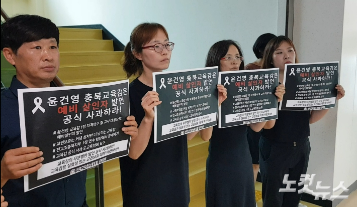 전교조 충북지부 조합원들이 26일 윤 교육감의 기자회견장 앞에서 피켓을 들고 항의하고 있다. 김종현 기자