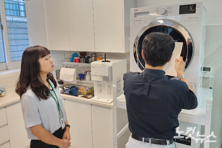 헬렌켈러 시청각장애인 학습지원센터에 마련된 일상생활훈련공간에서 시청각장애인이 점자를 통해 세탁기를 조작해보고 있다.