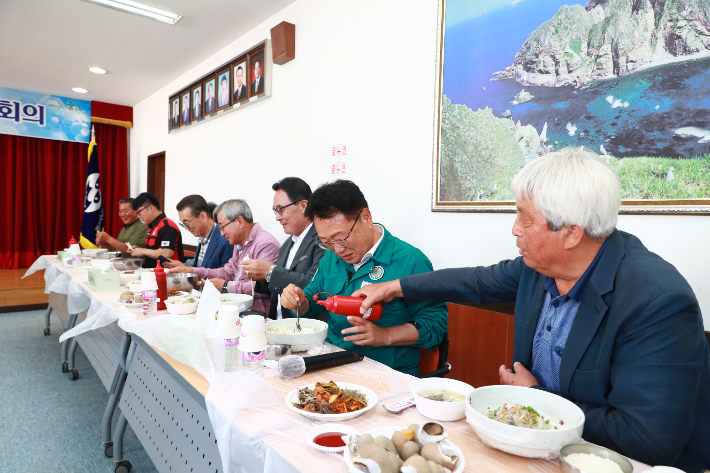 손병복 울진군수가 지역 수산물 소비 촉진을 위한 오찬 회의를 가진 뒤 수산물로 점심을 먹고 있다. 울진군 제공