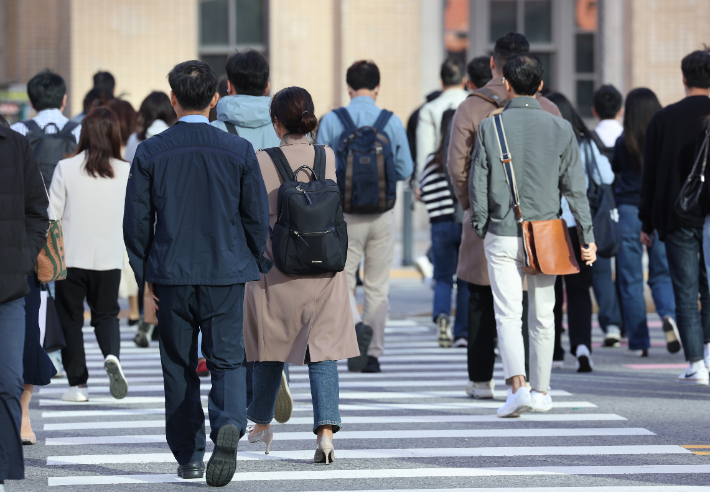 쌀쌀한 가을 날씨를 보인 5일 오전 출근길 서울 종로구 광화문네거리에서 외투와 긴팔 옷을 입은 시민들이 발걸음을 재촉하고 있다. 연합뉴스