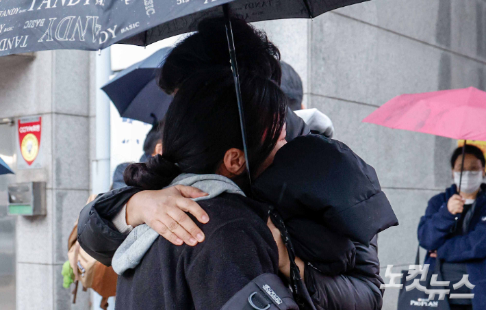 16일 서울 중구 이화여자고등학교에서 수능시험을 마친 수험생들이 시험장을 나선 뒤 마중나온 부모님과 포옹하고 있다. 박종민 기자
