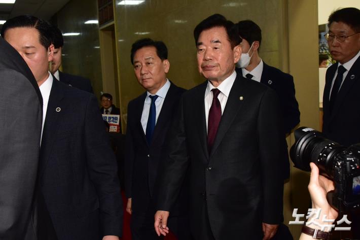 김진표 국회의장이 30일 서울 여의도 국회 의장실 앞에서 국민의힘 의원들이 규탄 구호를 외치는 가운데 본회의장으로 향하고 있다.