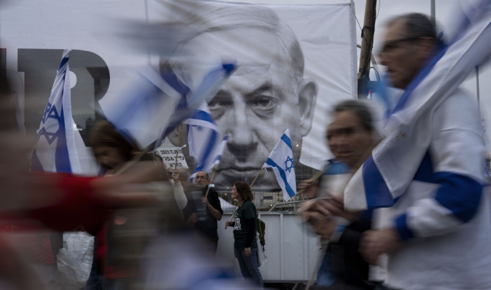 베냐민 네타냐후 이스라엘 총리의 얼굴이 그려진 현수막 앞을 행진하는 시위대. 연합뉴스