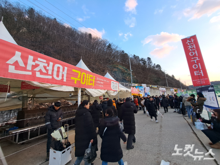 축제장에 마련된 산천어 구이터에 관광객들이 줄지어 서 있다. 진유정 기자