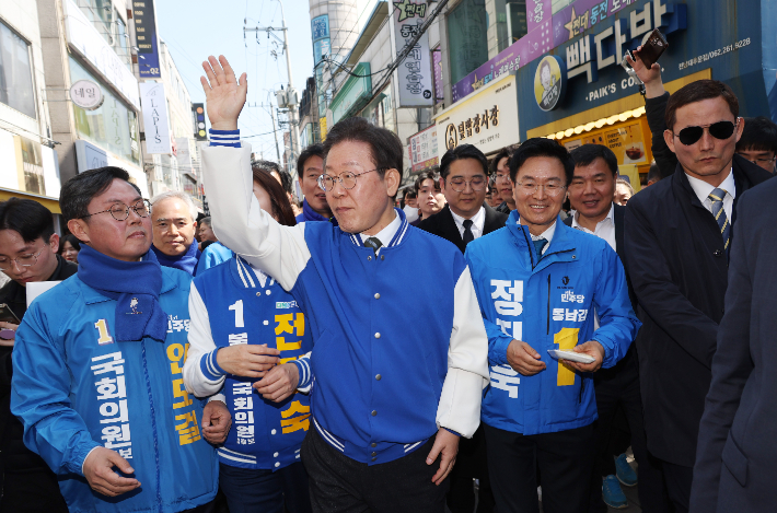 더불어민주당 이재명 상임공동선대위원장이 21일 광주 전남대 후문 상가 밀집지역을 방문, 이 지역에 출마한 후보들과 함께 거리 인사를 하고 있다. 연합뉴스 