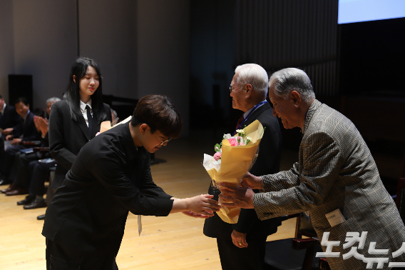 숭실대 24학번 학생들이 서울 숭실 1회 졸업생인 54학번 동문들에게 꽃다발을 전달하고 있다. 