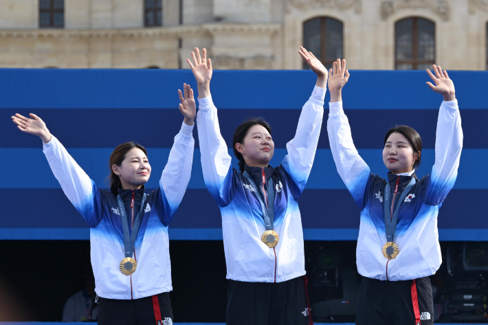 28일(현지시간) 프랑스 파리 앵발리드 경기장에서 열린 2024 파리올림픽 양궁 여자 리커브 단체 결승 한국과 중국의 경기. 양궁대표팀 (왼쪽부터)전훈영, 임시현, 남수현이 시상대에 올라 손을 흔들고 있다. 파리=올림픽사진공동취재단