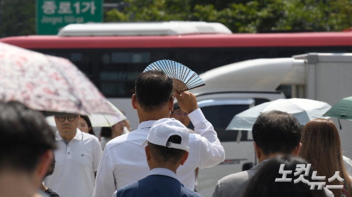 광화문사거리에서 한 시민이 부채로 햇빛을 가리고 있다. 박종민 기자