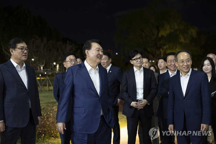 (서울=연합뉴스) 홍해인 기자 = 윤석열 대통령이 24일 서울 용산 대통령실 앞 분수정원에서 열린 국민의힘 지도부 초청 만찬 뒤 한동훈 대표, 추경호 원내대표 등 국민의힘 지도부, 대통령실 참모진과 함께 산책을 하고 있다. 2024.9.24 [대통령실 제공. 재판매 및 DB 금지] hihong@yna.co.kr 연합뉴스