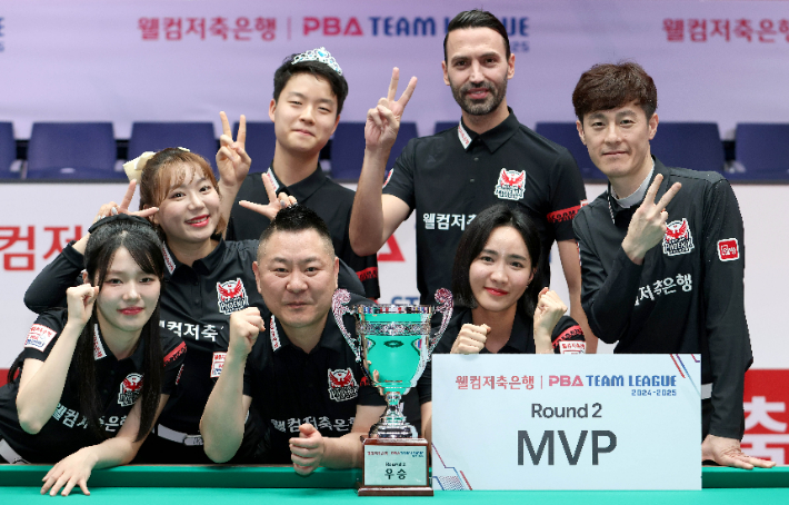 MVP 최혜미 등 웰컴저축은행 선수들이 '웰컴저축은행 PBA 팀 리그 2024-25' 2라운드 우승을 확정한 뒤 트로피를 들고 세리머니를 펼치고 있다. PBA