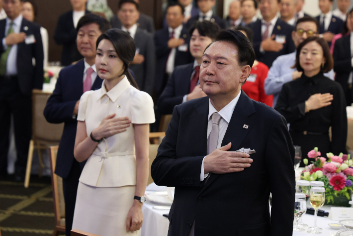 필리핀을 국빈 방문한 윤석열 대통령과 김건희 여사가 6일 오후(현지시간) 필리핀 마닐라 페닌슐라 호텔에서 열린 동포 만찬 간담회에서 국기에 경례하고 있다. 연합뉴스 