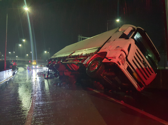 부산의 한 고속도로에서 화물차가 빗길에 미끄러져 운전자가 경상을 입었다. 부산경찰청 제공