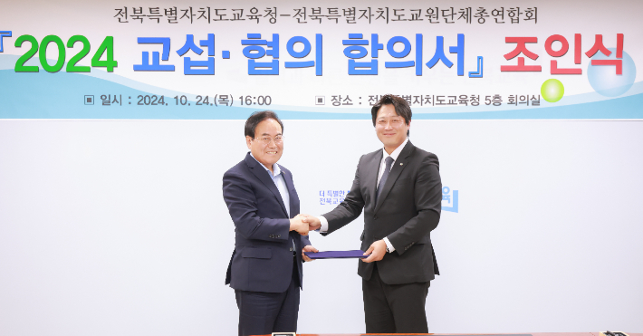 서거석 전북교육감과 오준영 전북교원단체총연합회 회장이 24일 '2024 교섭-협의 합의서' 조인식에서 악수하고 있다. 전북교육청 제공