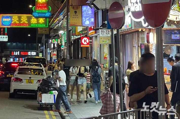 경제 침체로 인해 중국에서 홍콩으로 건너온 인재들 상당수가 보험 중개인으로 활동하고 있다는 보도가 나왔다. 사진은 홍콩 밤거리를 걸어가는 시민들.