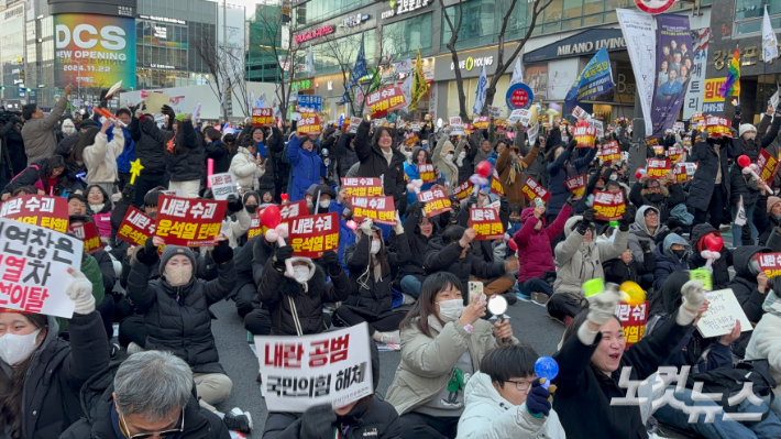 14일 오후 5시 대전 서구 은하수네거리 집회에 참석한 시민들이 탄핵소추안 가결 소식에 환호하고 있다. 김미성 기자