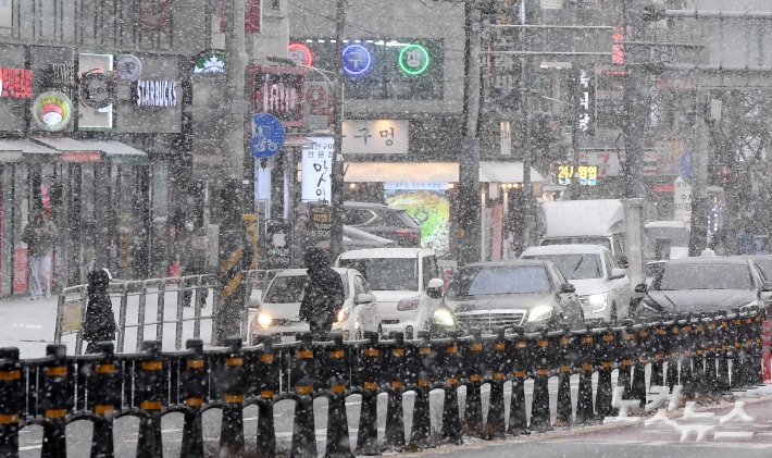 서울 전역에 대설주의보가 내려진 6일 오후 서울 강서구 화곡역 인근에서 시민들이 눈을 맞으며 걷고 있다. 황진환 기자