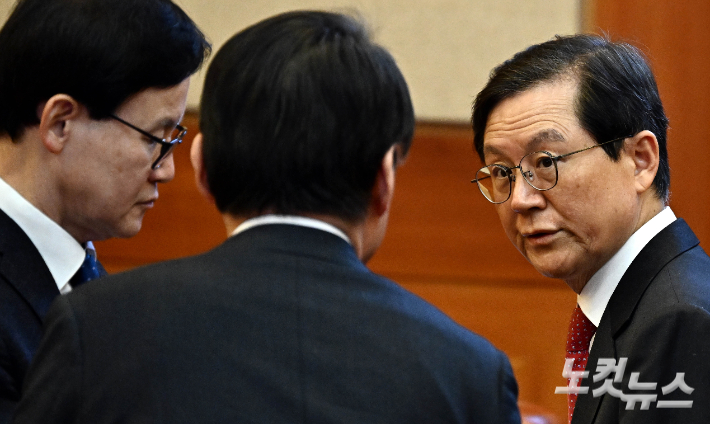 윤석열 대통령 법률대리인단 윤갑근 변호사가 지난 1월 23일 오후 서울 종로구 헌법재판소에서 열린 윤석열 대통령 탄핵 심판 4차 변론기일에 출석해 변호인단과 대화를 하고 있다. 사진공동취재단