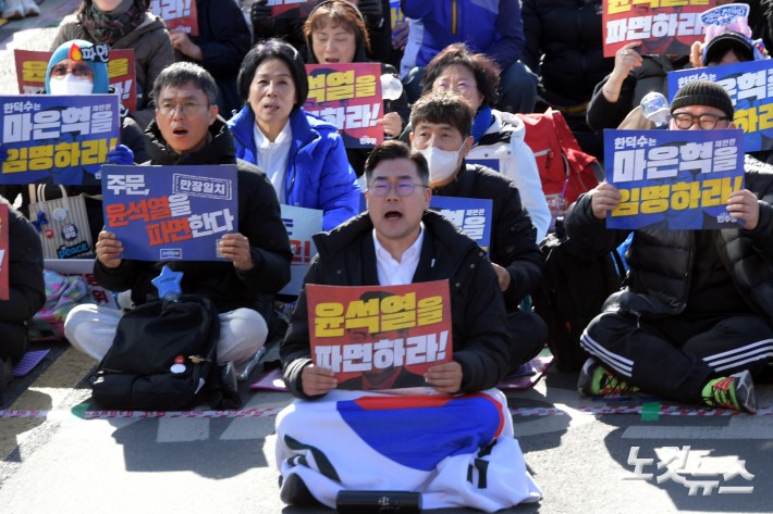 29일 서울 광화문 동십자각 일대에서 열린 야5당 공동 비상시국 대응을 위한 범국민대회에서 더불어민주당 박찬대 원내대표가 피켓을 들고 구호를 외치고 있다.