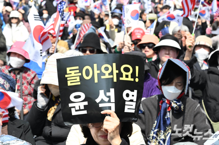 4일 오전 헌법재판소가 윤석열 대통령 파면 결정을 내리자 서울 용산구 한남동 대통령 관저 앞에서 탄핵 반대 집회 한 참가자가 윤석열 대통령의 복귀를 바라는 피켓을 들고 있다. 황진환 기자