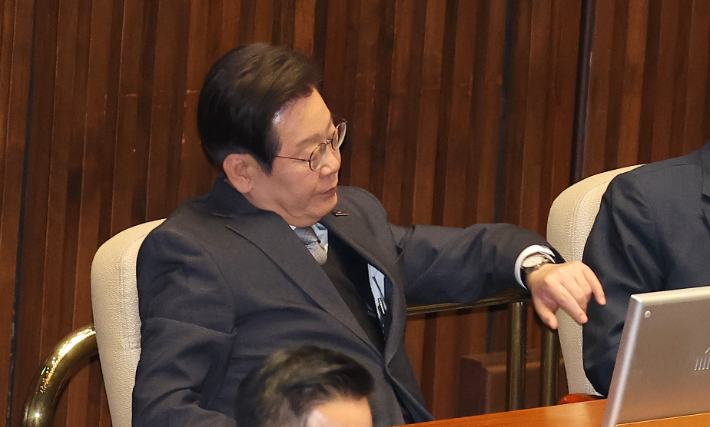 더불어민주당 이재명 대표가 윤석열 전 대통령에 대한 파면이 선고된 4일 서울 여의도 국회 본회의장에서 열린 '12.3. 윤석열 비상계엄을 해제한 대한민국 국민께 드리는 감사문에 대한 수정안' 표결을 마친 뒤 시계를 보고 있다. 연합뉴스