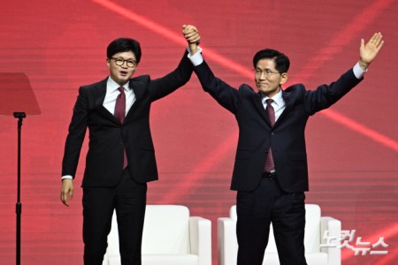 3일 경기도 일산 킨텍스에서 열린 국민의힘 제21대 대통령 선거 후보 선출을 위한 제5차 전당대회에서 한동훈 후보가 대선 후보로 선출된 김문수 후보의 손을 들어보이고 있다.