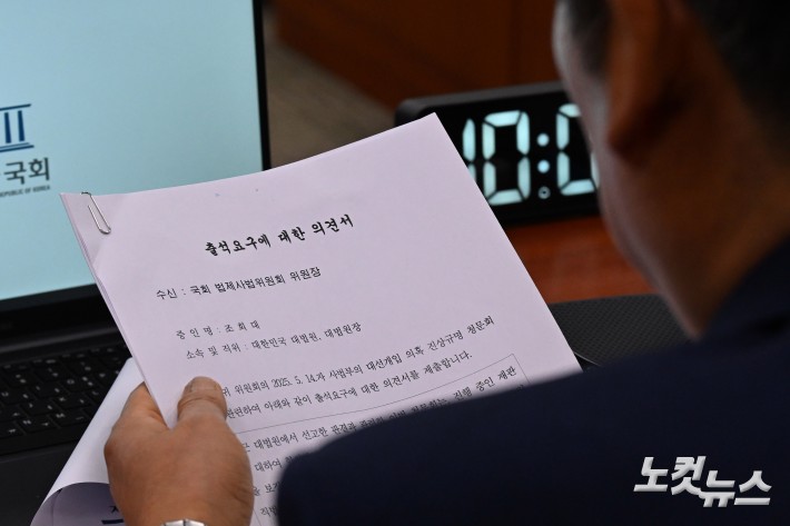 정청래 법사위원장이 14일 서울 여의도 국회에서 열린 법제사법위원회 전체회의에서 조희대 대법원장의 출석요구에 대한 의견서를 바라보고 있다.