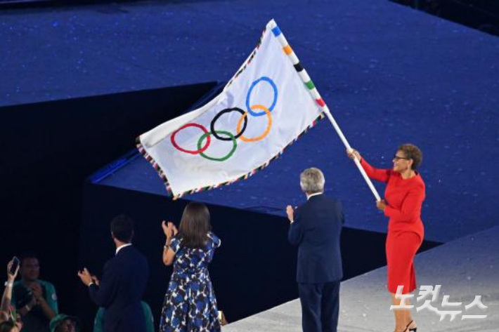 지난 2024 파리올림픽 폐회식에서 토마스 바흐 IOC위원장이 캐런 배스 LA 시장에게 올림픽기를 전달하고 있다. 황진환 기자