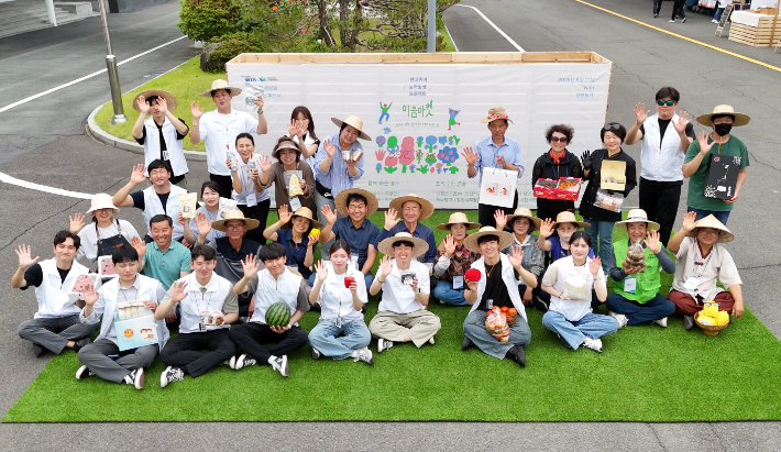 지난 21일 경상남도 창원특례시 현대위아 본사에서 열린 '이음마켓'에 참여한 농부들이 기념 사진을 찍고 있다. 현대위아 제공
